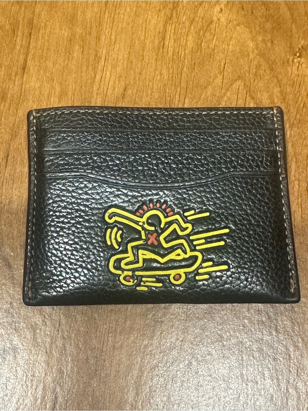Coach Black Pebbled Leather Card Holder with Yellow & Red Skate Graphic